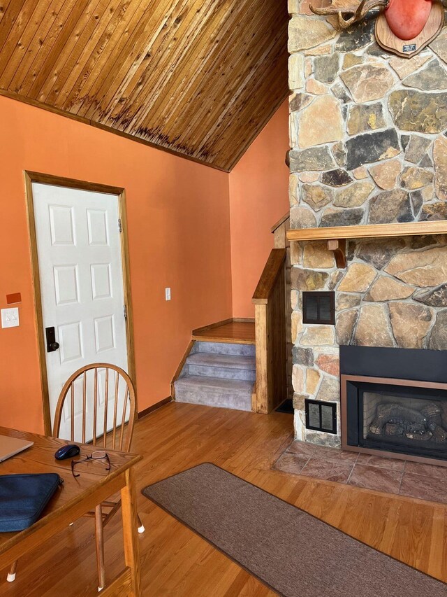 32 Dillon Rd, Harrison, ME 04040 - unfurnished living room featuring wood finished floors, lofted ceiling, wooden ceiling, a fireplace, and stairs