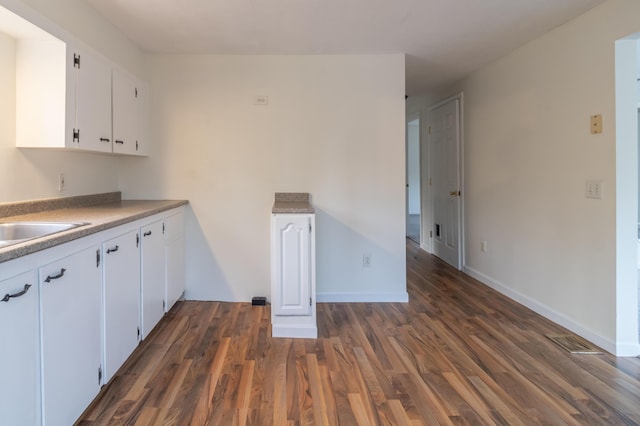 kitchen featuring white cabinetry, sink, and dark hardwood / wood-style flooring