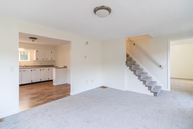 unfurnished living room featuring carpet