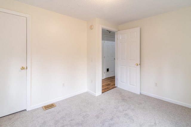 unfurnished bedroom featuring light colored carpet