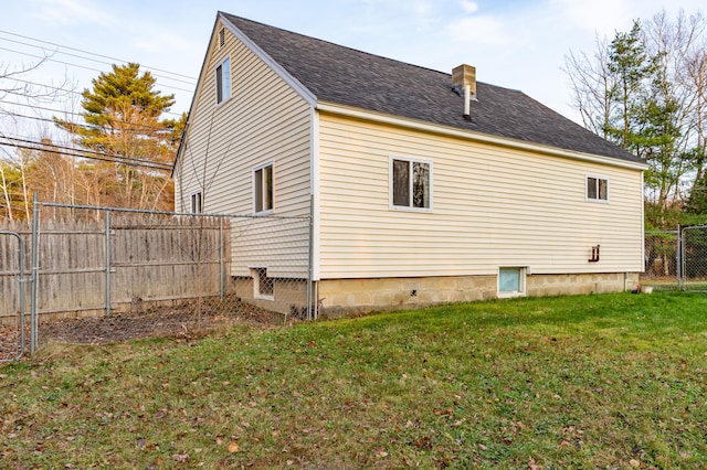 view of side of home with a yard