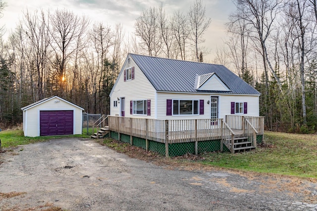 view of front of house with a garage, an outdoor structure, and a deck