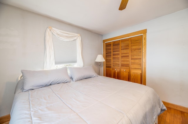 bedroom with a closet, ceiling fan, and wood-type flooring