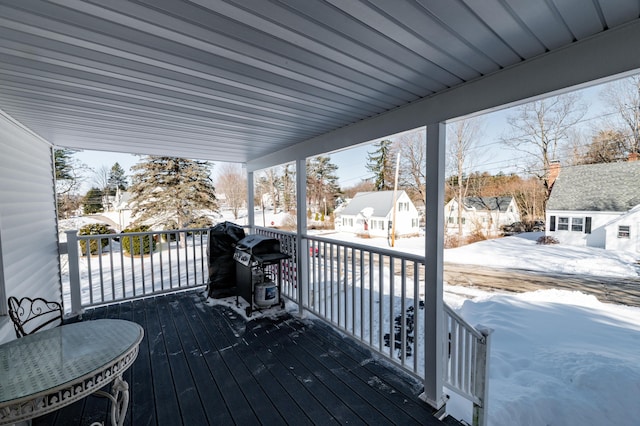 snow covered deck featuring area for grilling