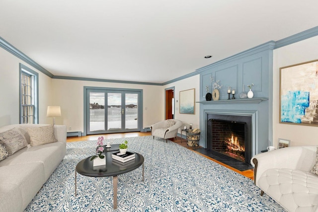 living room with a fireplace with flush hearth, a baseboard heating unit, crown molding, and wood finished floors