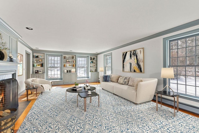 living area with a fireplace with flush hearth, a baseboard radiator, crown molding, and wood finished floors