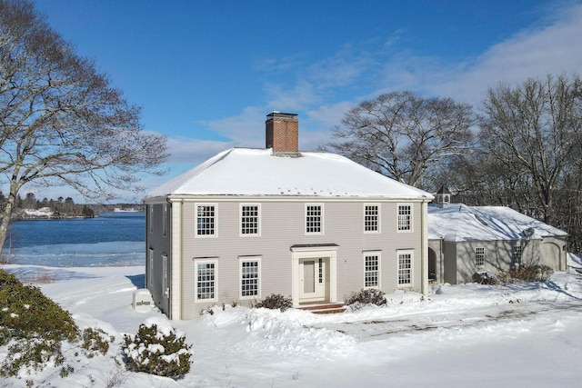 snow covered house with a chimney