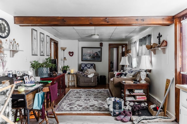 interior space featuring hardwood / wood-style flooring, a baseboard heating unit, and beamed ceiling