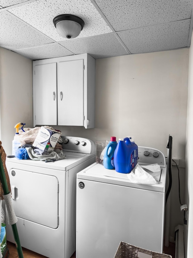 laundry room with washing machine and dryer and cabinets