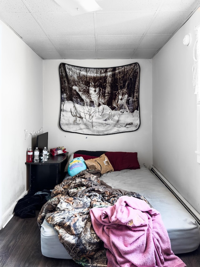 bedroom with hardwood / wood-style flooring and a paneled ceiling