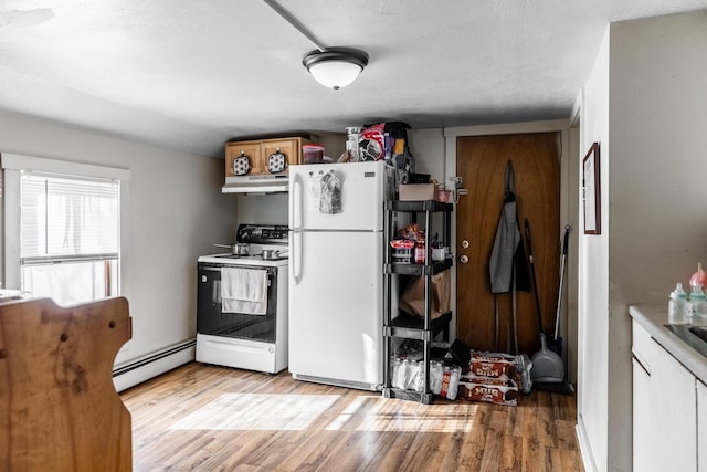 kitchen featuring white appliances, light hardwood / wood-style flooring, and a baseboard heating unit