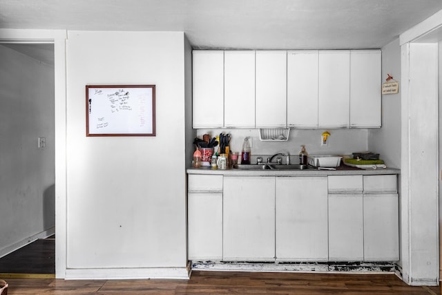 kitchen with white cabinetry, sink, and dark hardwood / wood-style flooring