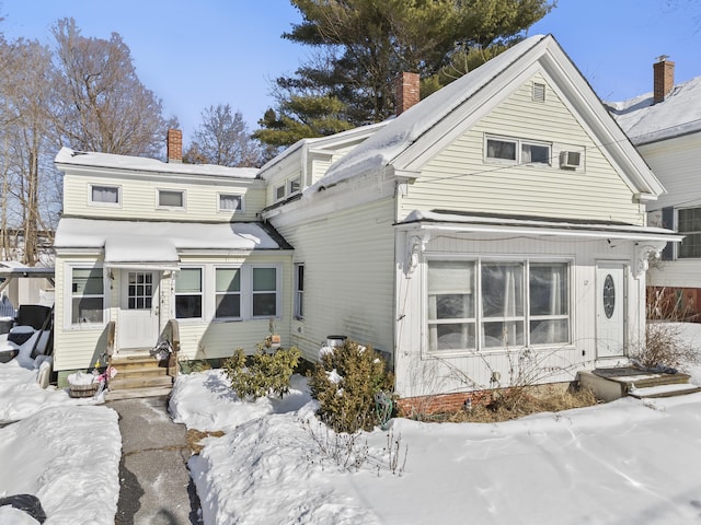 view of snow covered back of property