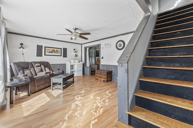 living room featuring crown molding, hardwood / wood-style floors, and ceiling fan