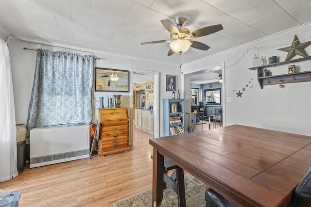 dining area featuring ornamental molding and light wood-type flooring