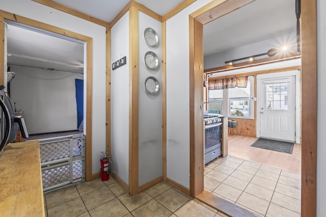 interior space featuring stainless steel gas range oven and light tile patterned flooring