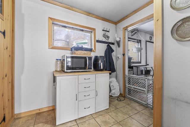 home office with light tile patterned floors