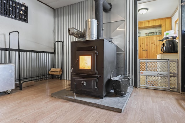 interior details with hardwood / wood-style floors and a wood stove