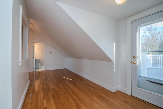 bonus room with lofted ceiling and wood-type flooring