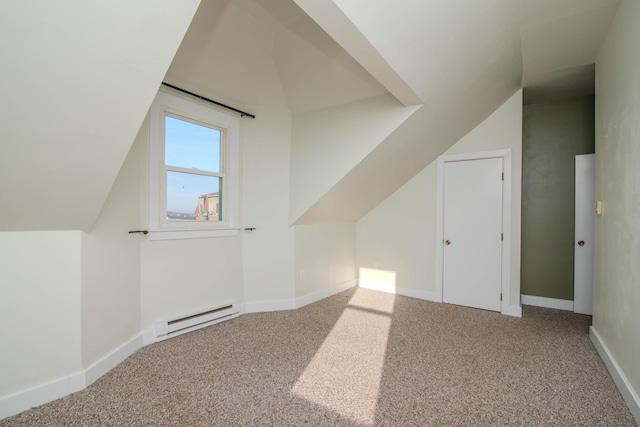 additional living space with a baseboard radiator, lofted ceiling, and carpet floors