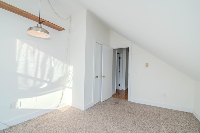 bonus room with lofted ceiling and carpet floors