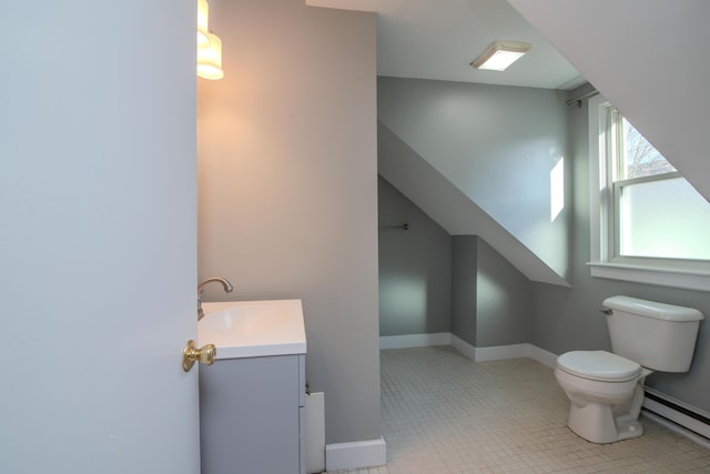 bathroom featuring vanity, tile patterned flooring, toilet, and baseboard heating