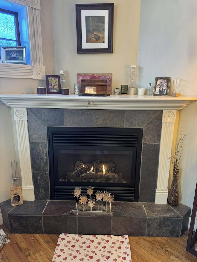 interior details with a fireplace and wood finished floors