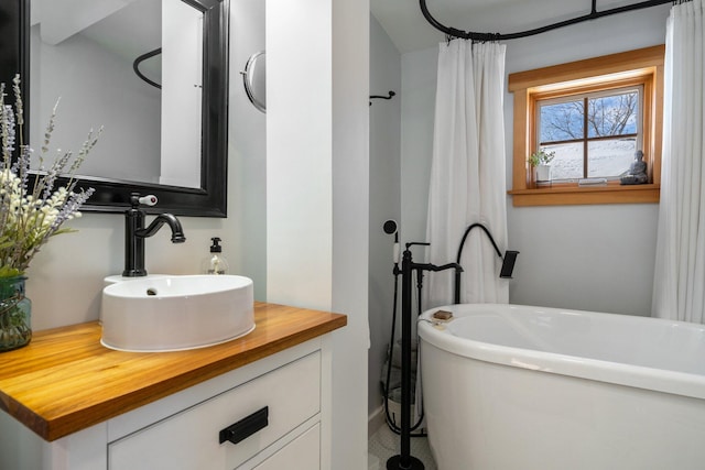 bathroom with a bath and vanity