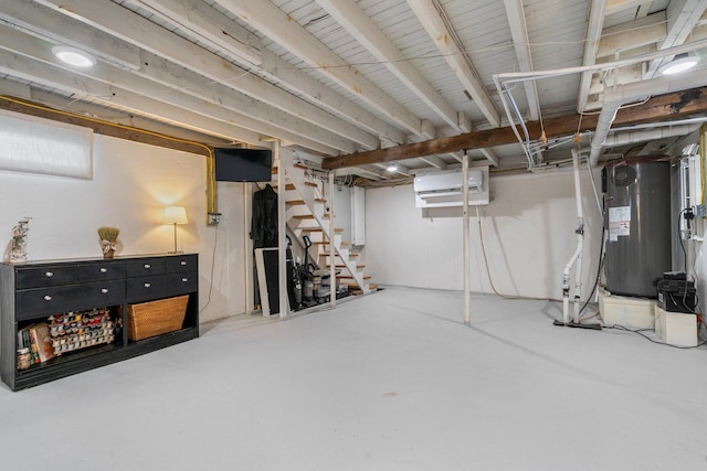 basement featuring a wall mounted AC and water heater