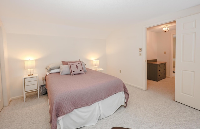 bedroom featuring baseboards and light colored carpet