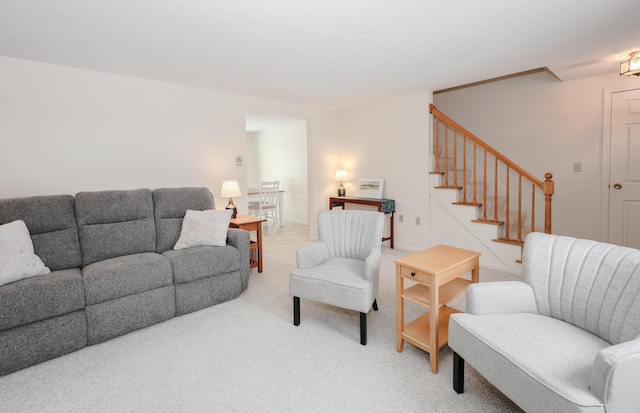 living area with carpet flooring and stairway