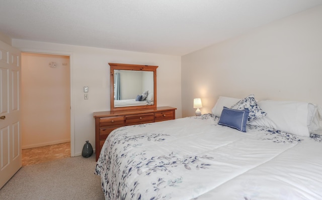 carpeted bedroom featuring baseboards