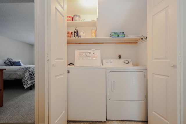 washroom with laundry area and washer and dryer