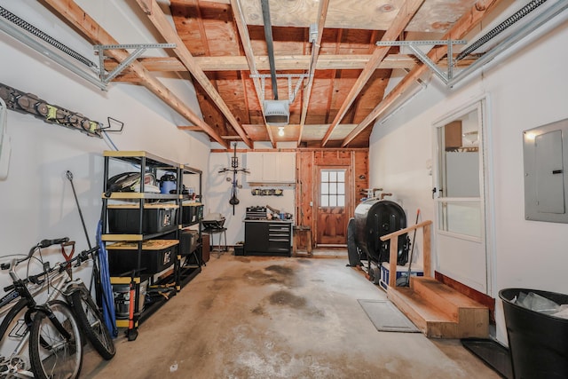 garage featuring heating fuel, electric panel, and a garage door opener