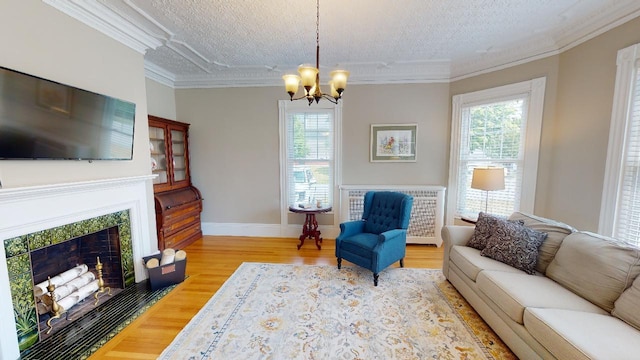 98 Fountain St, Bangor, ME 04401 - living room with crown molding, plenty of natural light, a textured ceiling, and light hardwood / wood-style floors