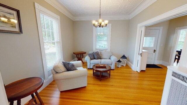 98 Fountain St, Bangor, ME 04401 - sitting room with hardwood / wood-style flooring, crown molding, and an inviting chandelier