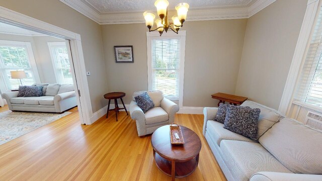 98 Fountain St, Bangor, ME 04401 - living room with hardwood / wood-style flooring, ornamental molding, and an inviting chandelier