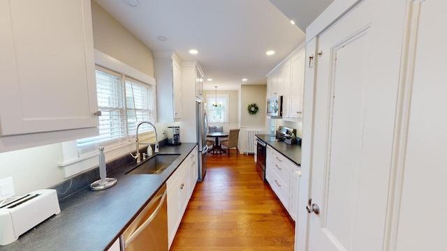 98 Fountain St, Bangor, ME 04401 - kitchen featuring white cabinetry, stainless steel appliances, decorative light fixtures, and sink