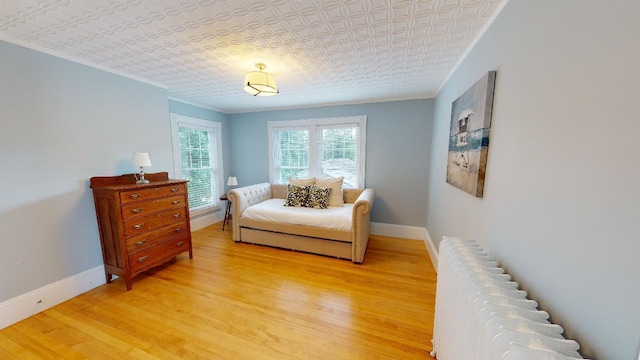 98 Fountain St, Bangor, ME 04401 - living area with radiator, wood-type flooring, and ornamental molding