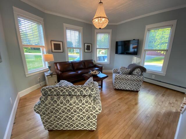 98 Fountain St, Bangor, ME 04401 - living room featuring a baseboard heating unit, hardwood / wood-style flooring, and ornamental molding