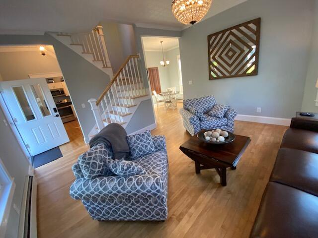98 Fountain St, Bangor, ME 04401 - living room featuring a notable chandelier, ornamental molding, and hardwood / wood-style floors