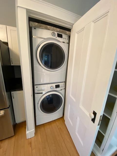 98 Fountain St, Bangor, ME 04401 - laundry area with light wood-type flooring and stacked washing maching and dryer