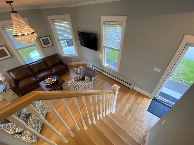 98 Fountain St, Bangor, ME 04401 - living room with a wealth of natural light, a baseboard heating unit, hardwood / wood-style floors, and ornamental molding