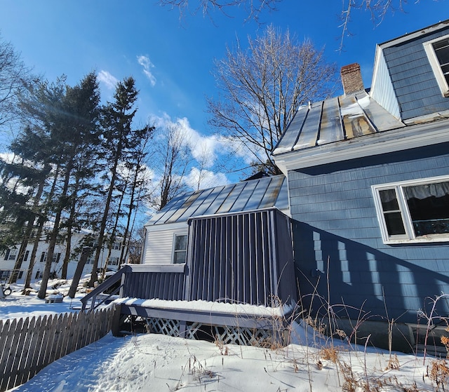 snow covered property featuring a wooden deck