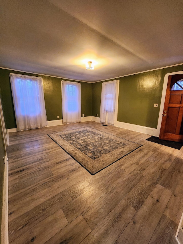 foyer featuring hardwood / wood-style floors and ornamental molding