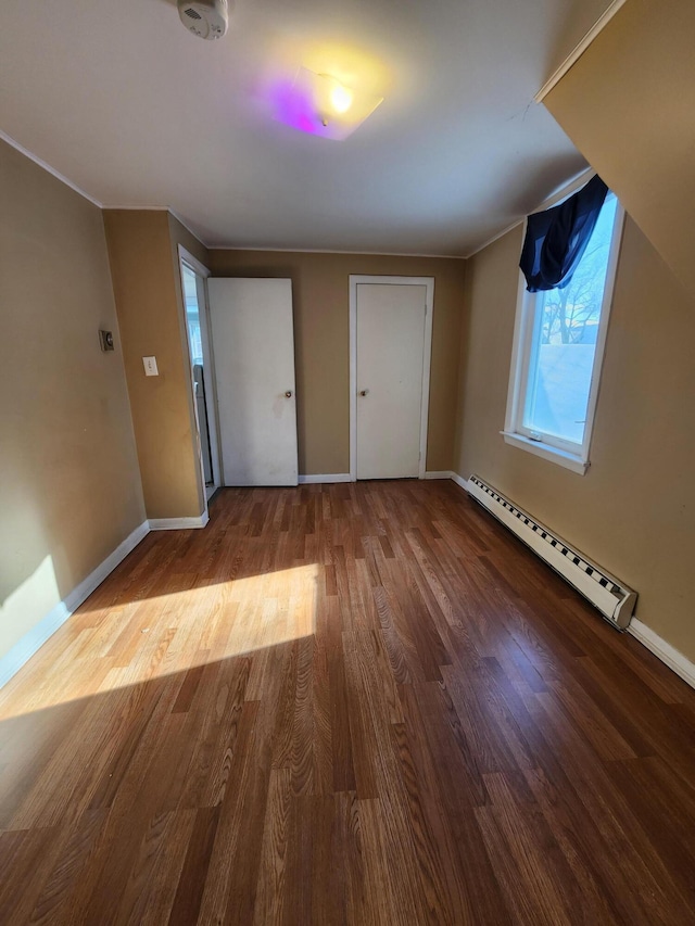 interior space featuring hardwood / wood-style floors and a baseboard heating unit