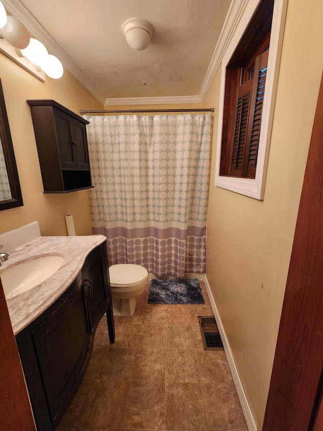 bathroom featuring vanity, crown molding, and toilet