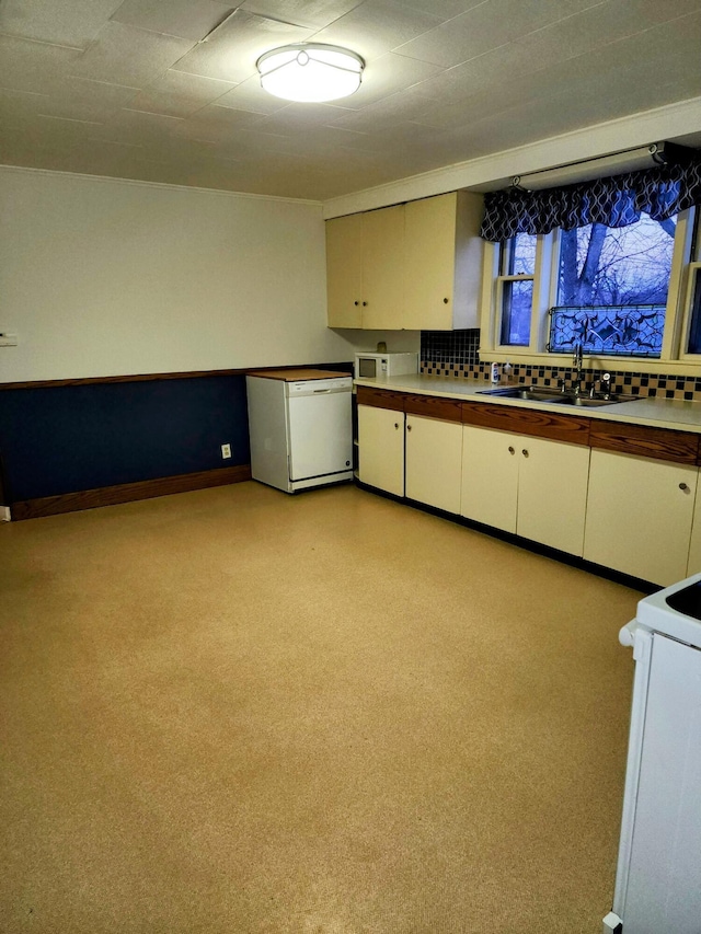 kitchen featuring white appliances, sink, decorative backsplash, and white cabinets