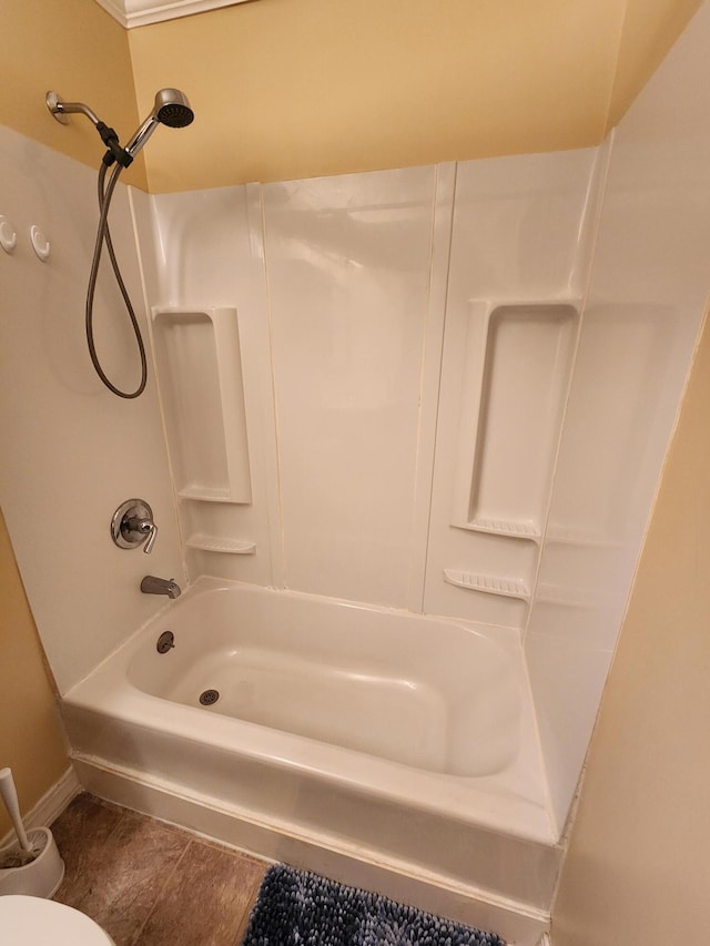 bathroom with hardwood / wood-style floors and washtub / shower combination