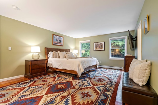 bedroom featuring a baseboard radiator and dark hardwood / wood-style floors